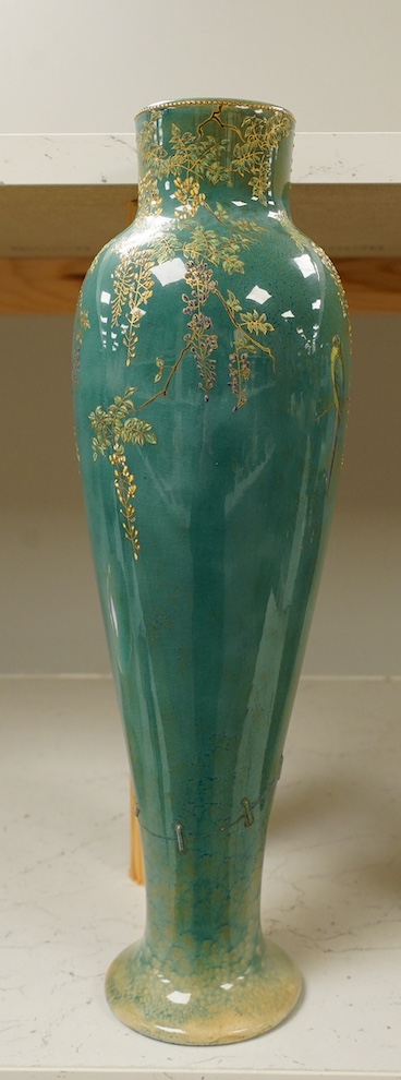 A Doulton Titanian ‘parakeet’ vase with raised floral and leaf design, 37cm high. Condition - considerable stapled restoration